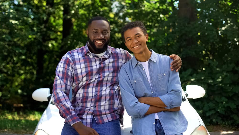 african american parent with teen driving for the first time