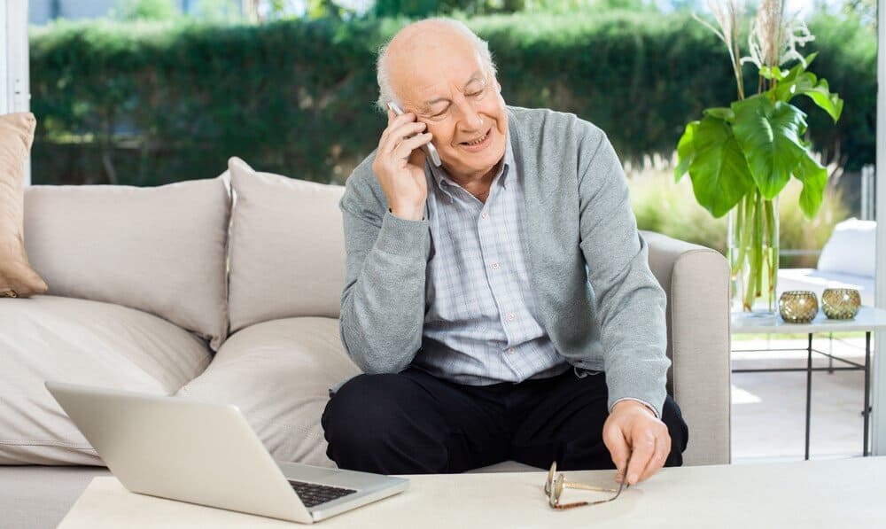 elderly man calling a doctor with a telemedicine plan