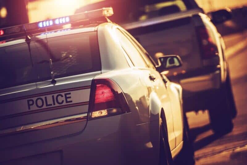 sr-22 insurance police car stopping a vehicle on the road