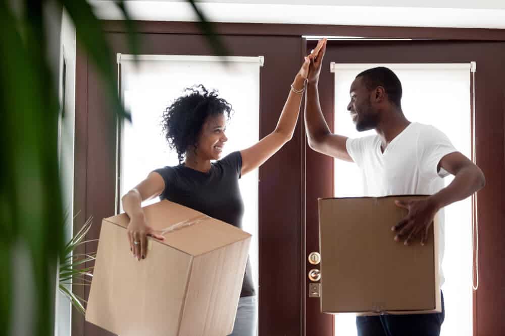 happy african american coulpe high fiving when renting for the first time