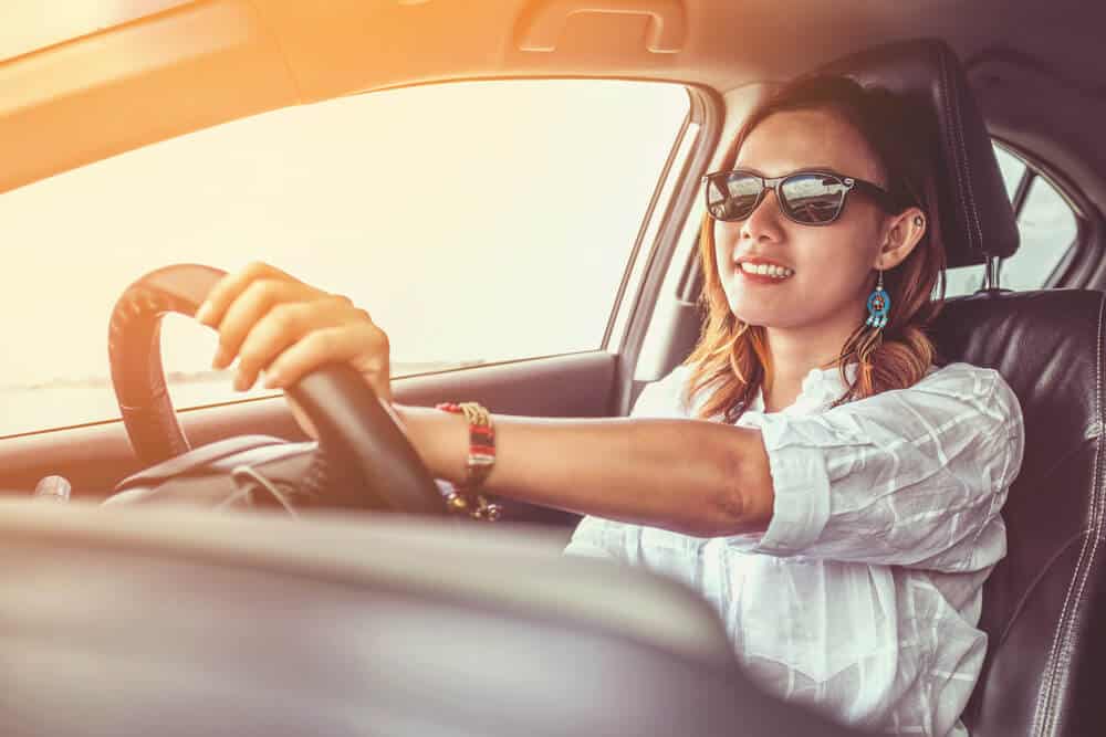 woman driving a car with low insurance rates