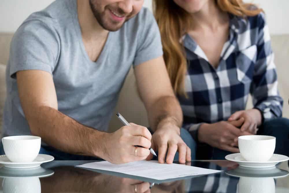 couple signing renters insurance policy