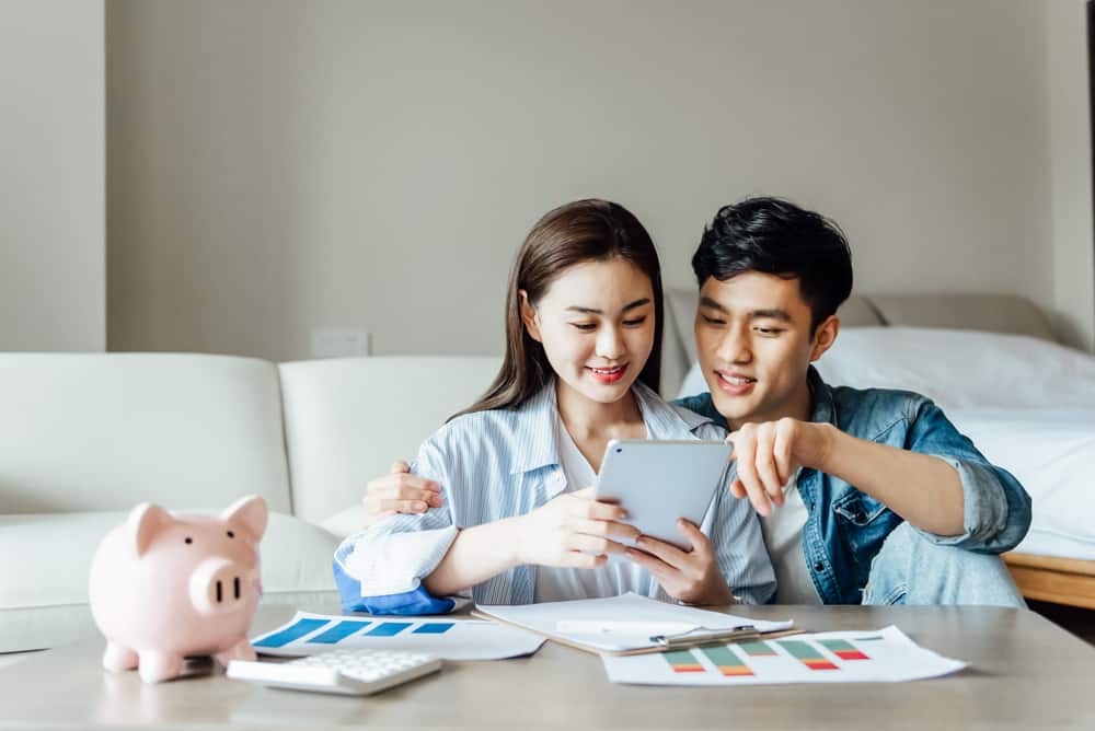 Young asian couple reviewing life insurance options