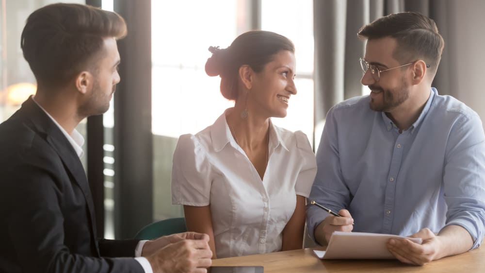 young couple talking to life insurance agent