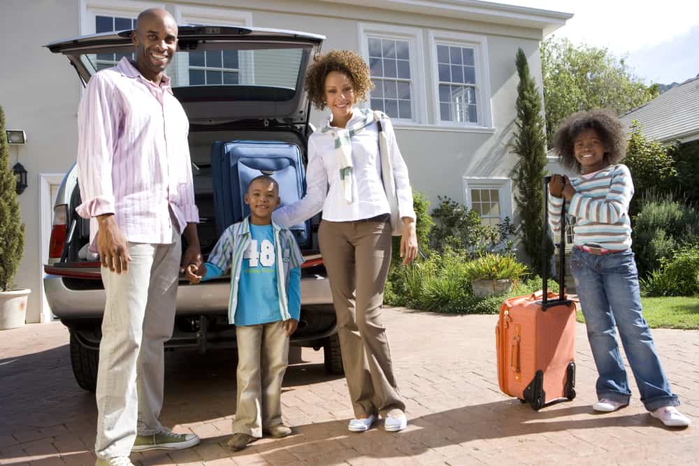 family packing up car for road trip