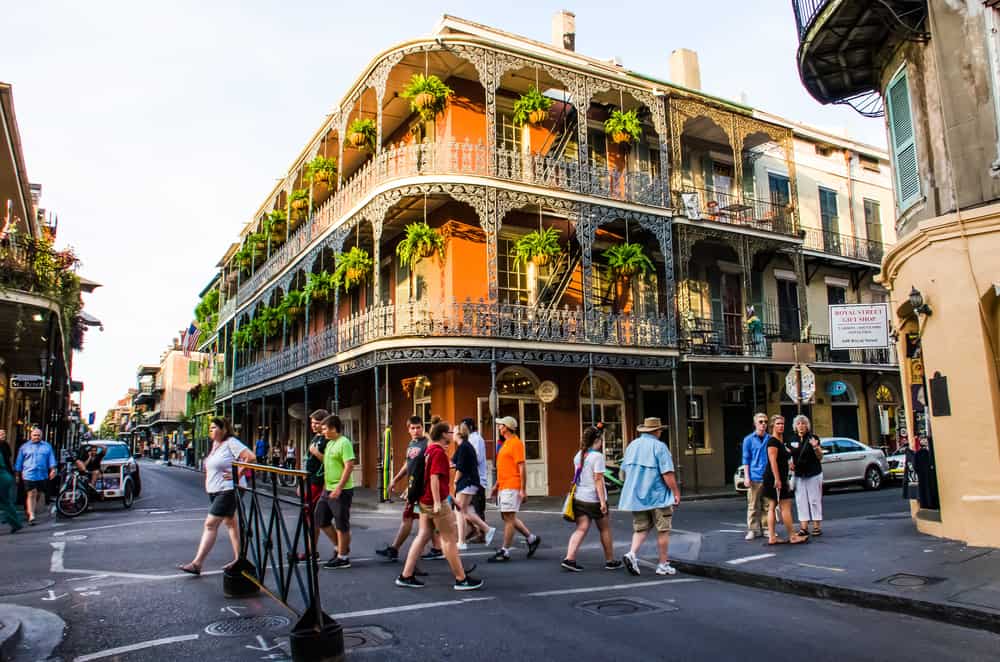 Driving around New Orleans and past a Spanish French-inspired building with iron metal balconies in French Quarter Louisiana
