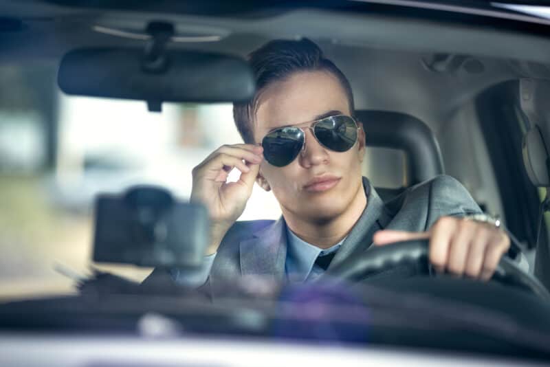 Business,Man,With,Sunglasses,Driving,A,Car Handsome man in sunglasses behind the wheel of a car